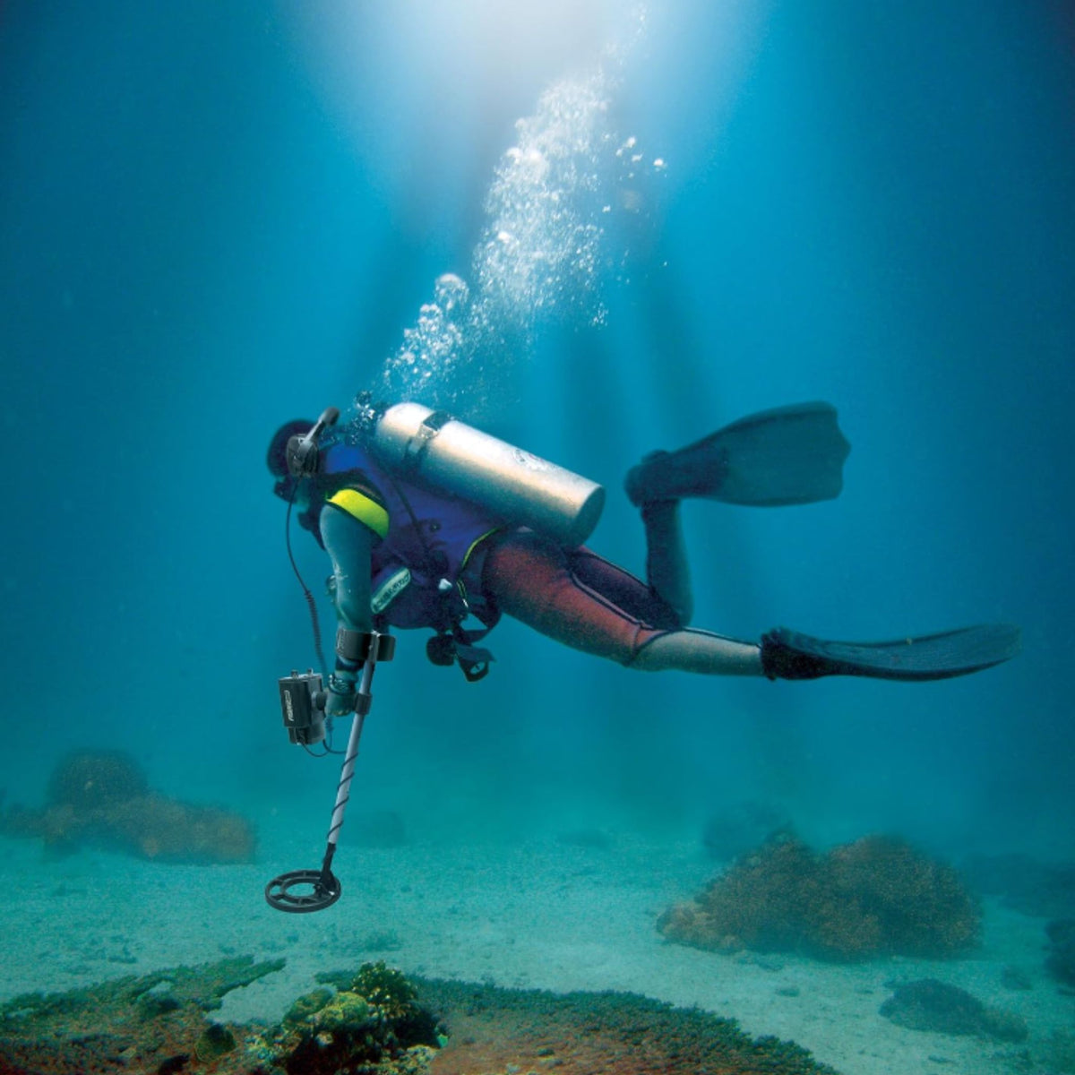Diver using a Fisher CZ-21 underwater metal detector